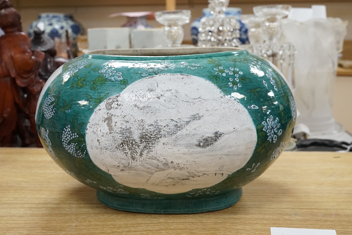 A Chinese enamelled porcelain oval bowl, Guandong kilns, early 20th century, green with en grisaille panels, 20cm high